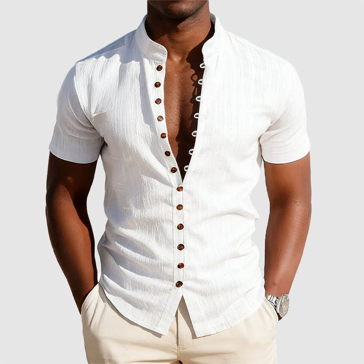 Model wearing a mandarin collar button-front shirt on a plain background.