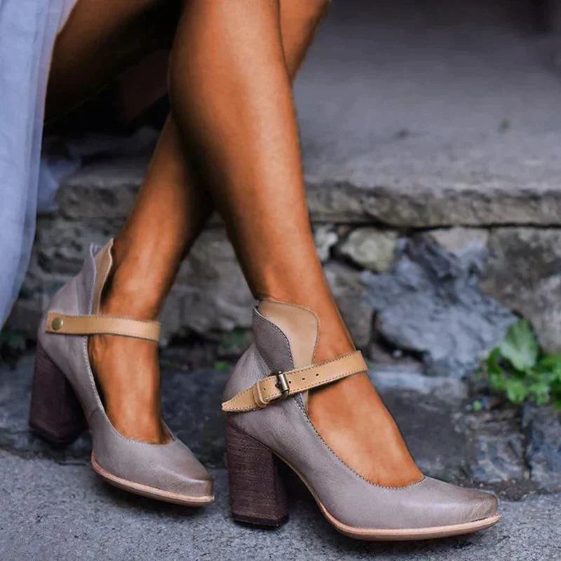 Close-up of a foot in stylish strappy heel sandals on a clean background.