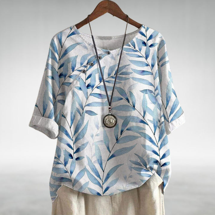 Relaxed chic blouse shown on a plain background with airy comfort and refined design details.