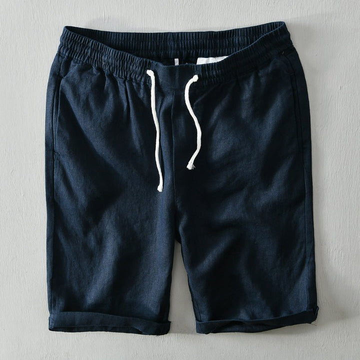  Male model displaying knee-length leisure shorts on a plain background.