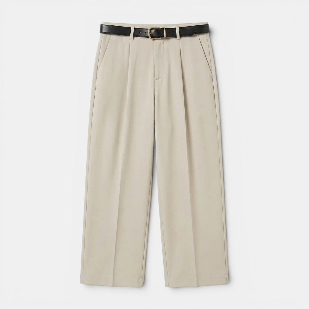 Ppleated tailored trousers for a polished appearance on a plain background.