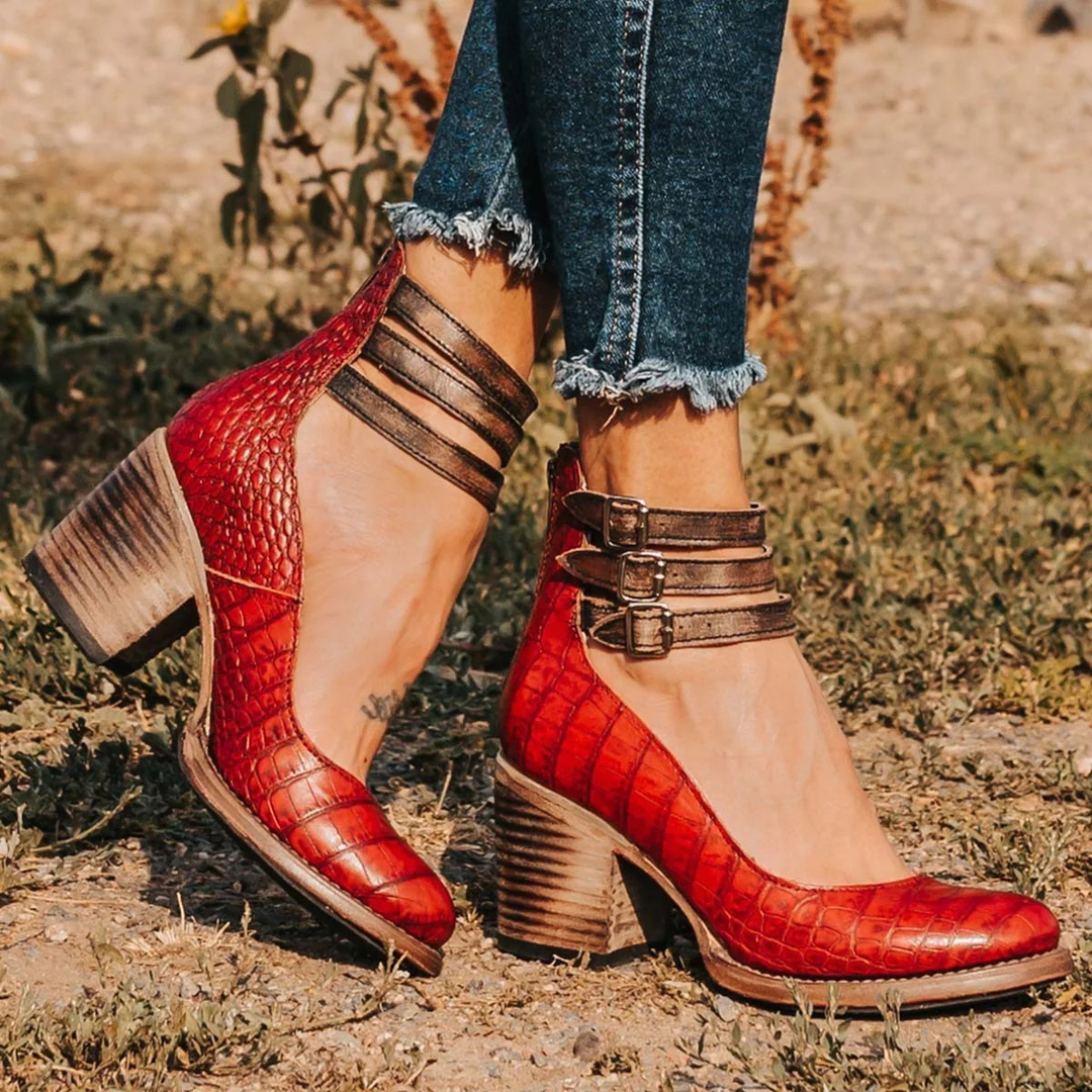 Female foot wearing versatile women’s sandal on a plain background.