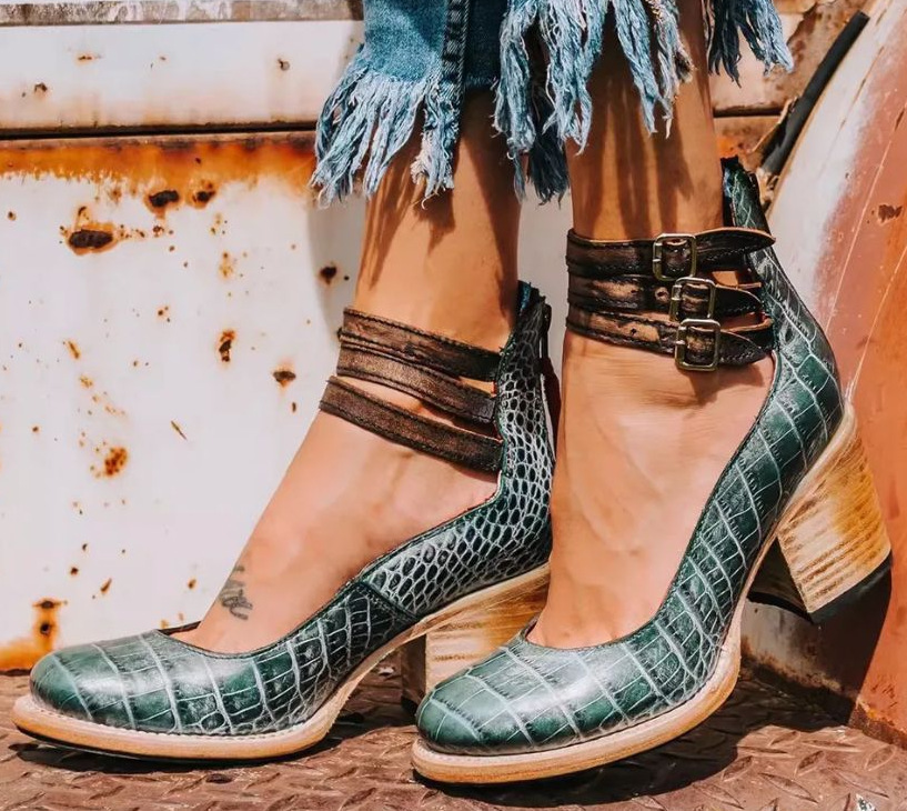Model foot in sophisticated comfort sandal against clean background.