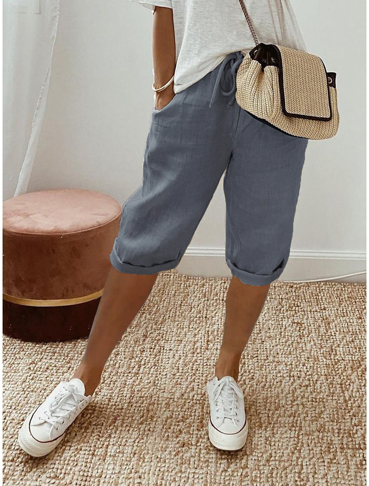 Lightweight capri pants displayed on a beige background with a relaxed leg shape.