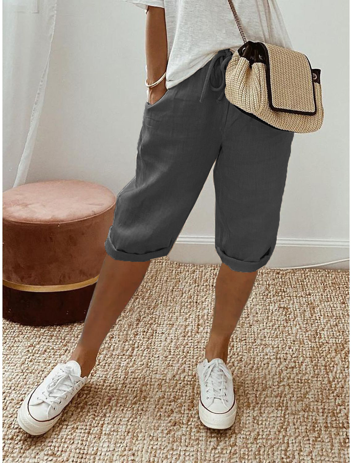 Breathable women’s capri pants shown on a beige background for everyday casual wear.