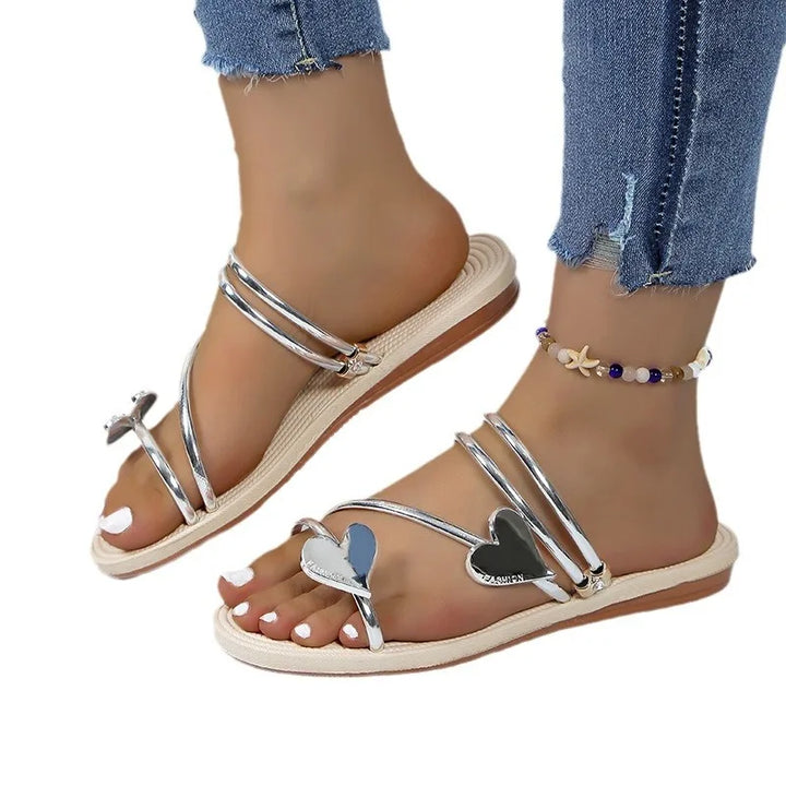 Stylish women’s rhinestone sandals displayed on a female model with clean background.