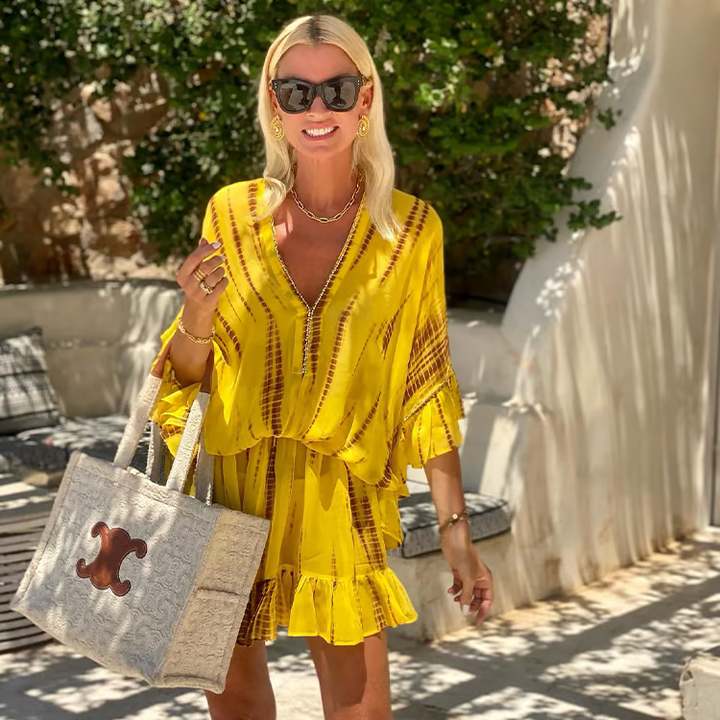 Woman wearing a chic V-neck high waist mini dress for a stylish feminine outfit.