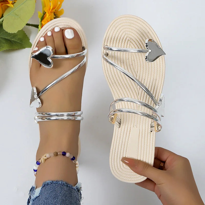 Female model wearing sparkling rhinestone sandals against a plain background.