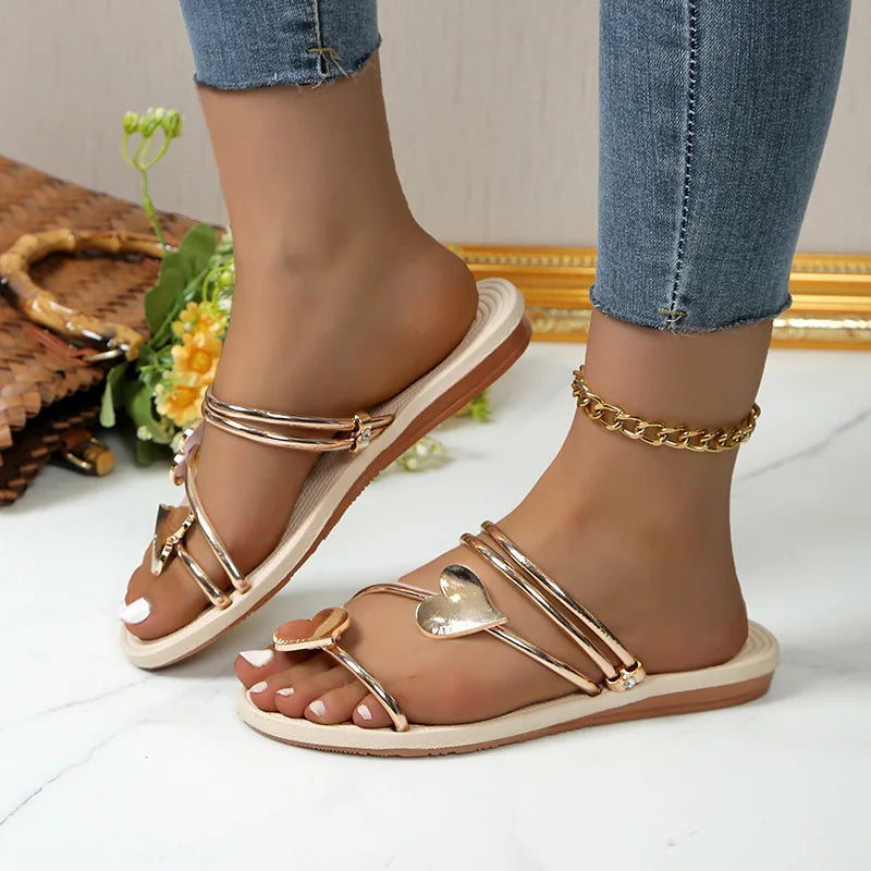 Woman showcasing glitter detail sandals with open toe styling on a plain backdrop.