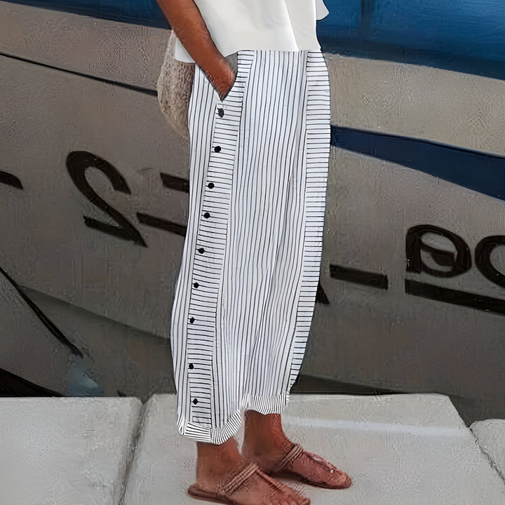 Female model wearing soft everyday pants with practical side pockets on a plain background.