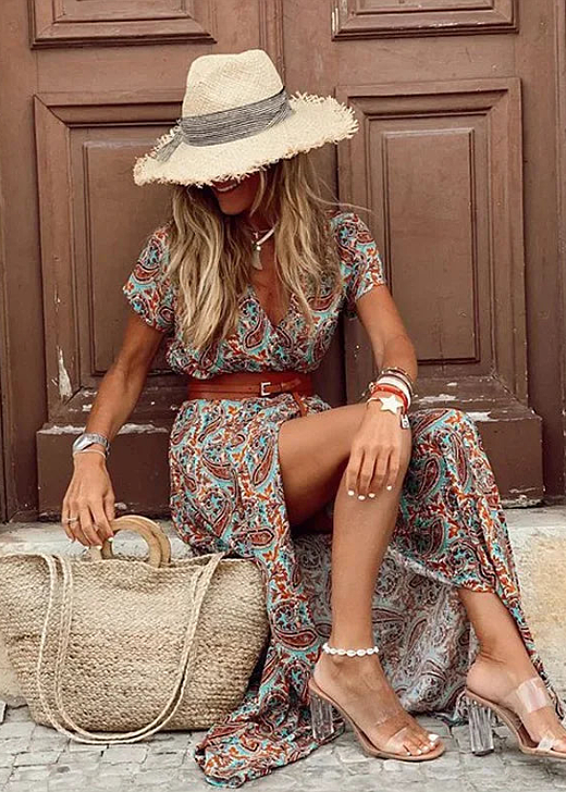 Woman modeling a casual printed maxi dress with relaxed fit and matching waist tie.