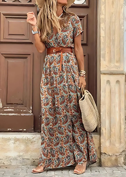 Female model showcasing a short sleeve printed maxi dress with long flowing length.