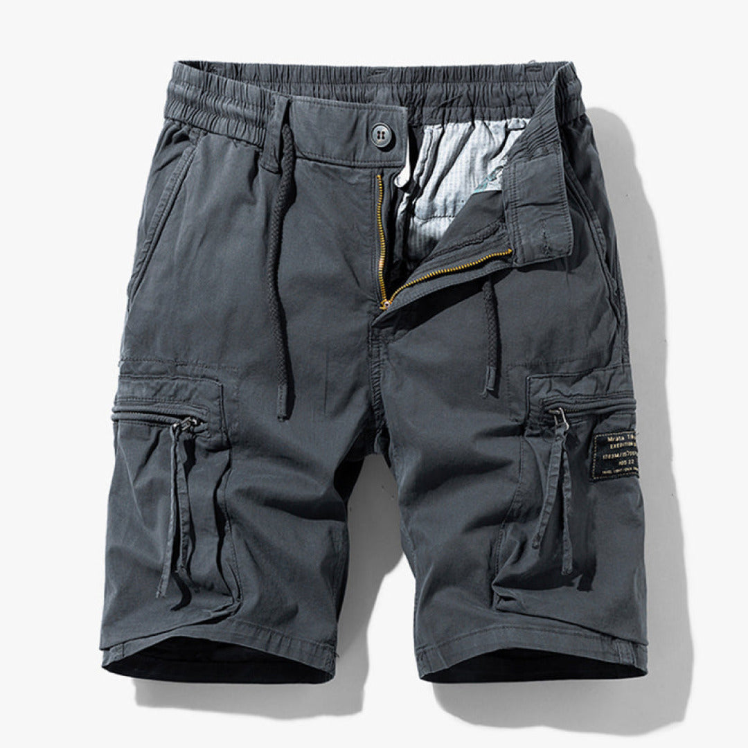 Loose fit cargo shorts with adjustable waist and pocket details on a plain background.