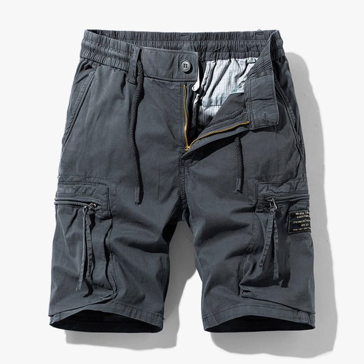 Loose fit cargo shorts with adjustable waist and pocket details on a plain background.