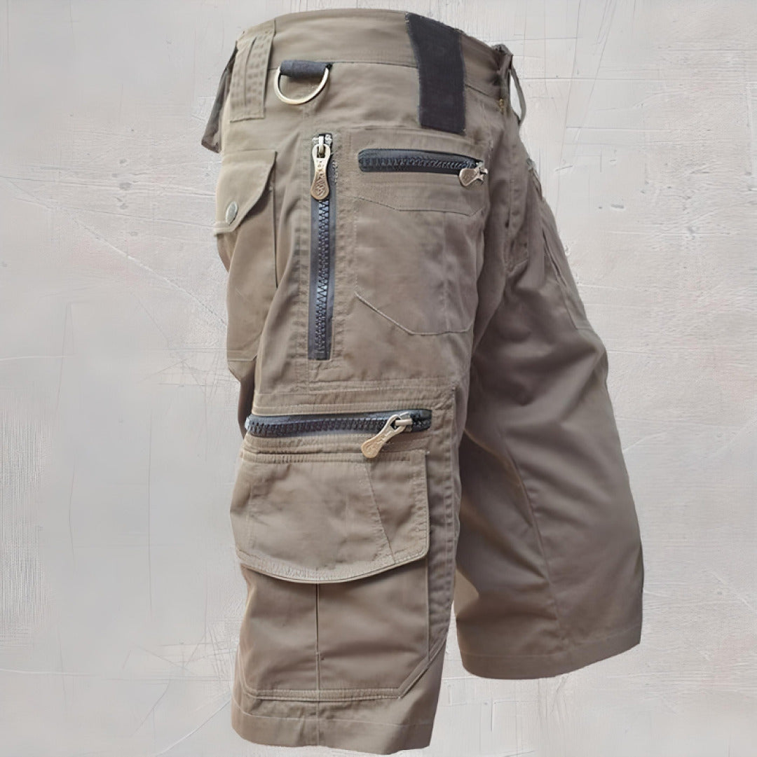  Woman showcasing relaxed fit cargo shorts with utility pocket details on a plain background.