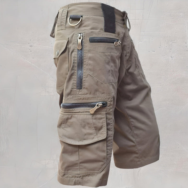  Woman showcasing relaxed fit cargo shorts with utility pocket details on a plain background.