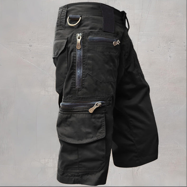 Female model wearing cargo shorts with zip pockets against a plain background.