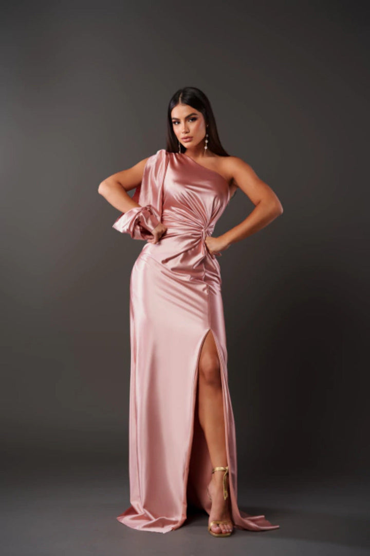 Female model in an elegant waist-defining maxi dress against a plain background.