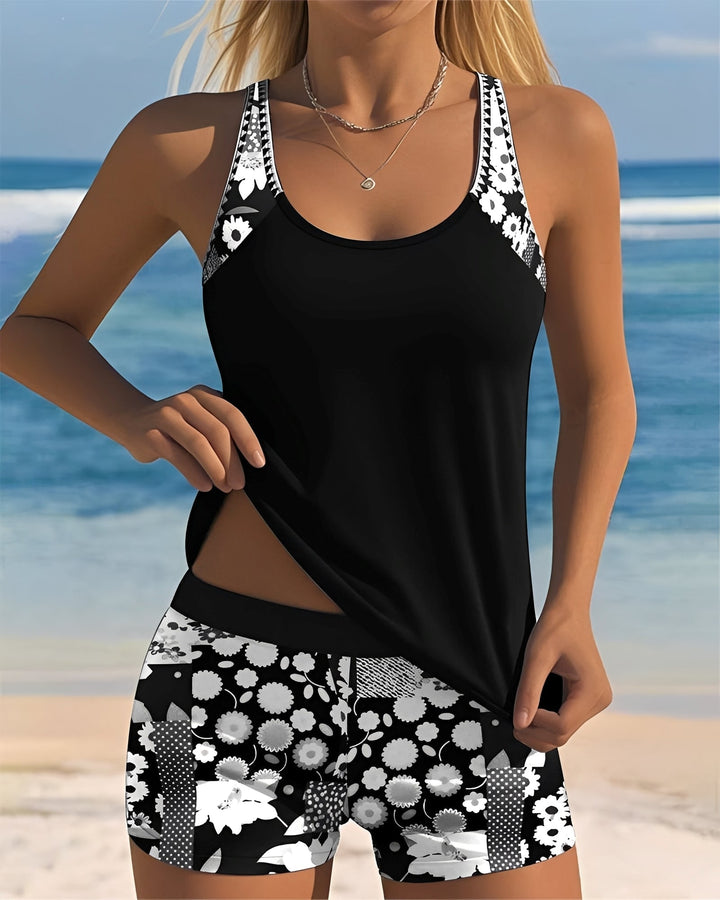 Female displaying a fashionable two-piece swimsuit on a plain background.