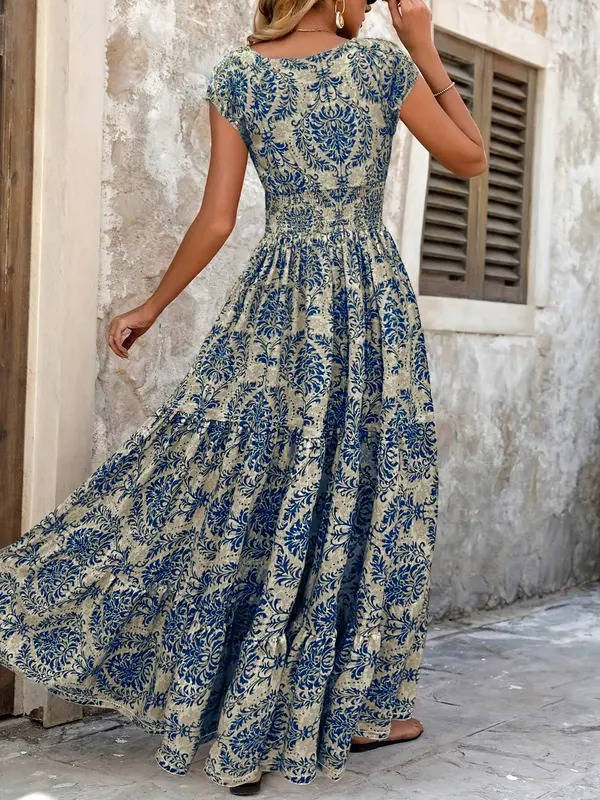 Woman posing in a lightweight maxi dress with flowing layers