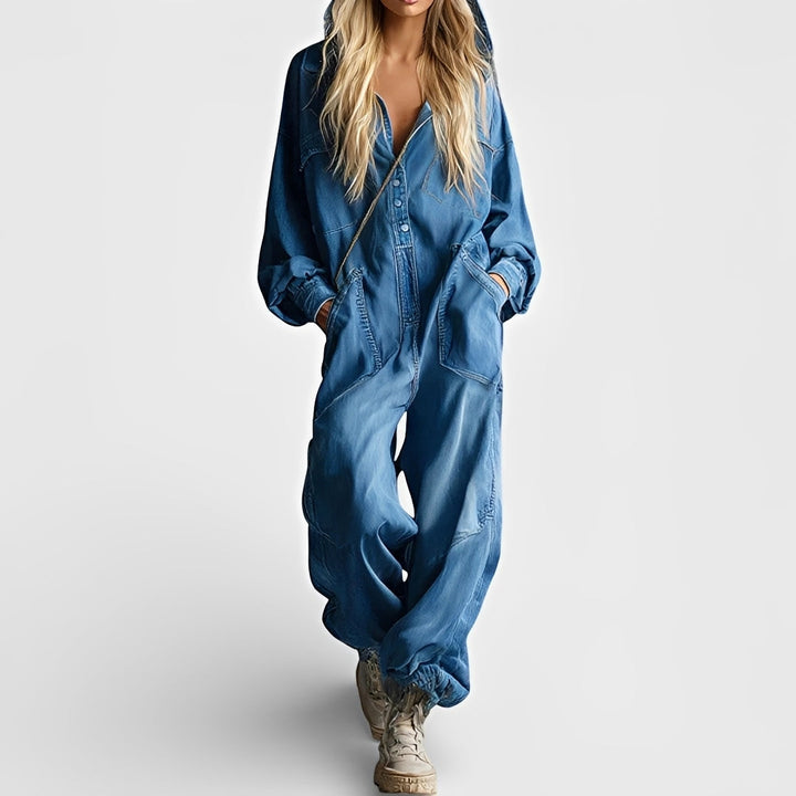 Woman showcasing a relaxed-fit jumpsuit styled for everyday wear on a plain background.