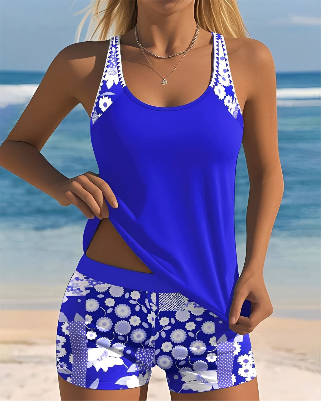  Woman wearing a printed tankini with a relaxed fit on a plain background.