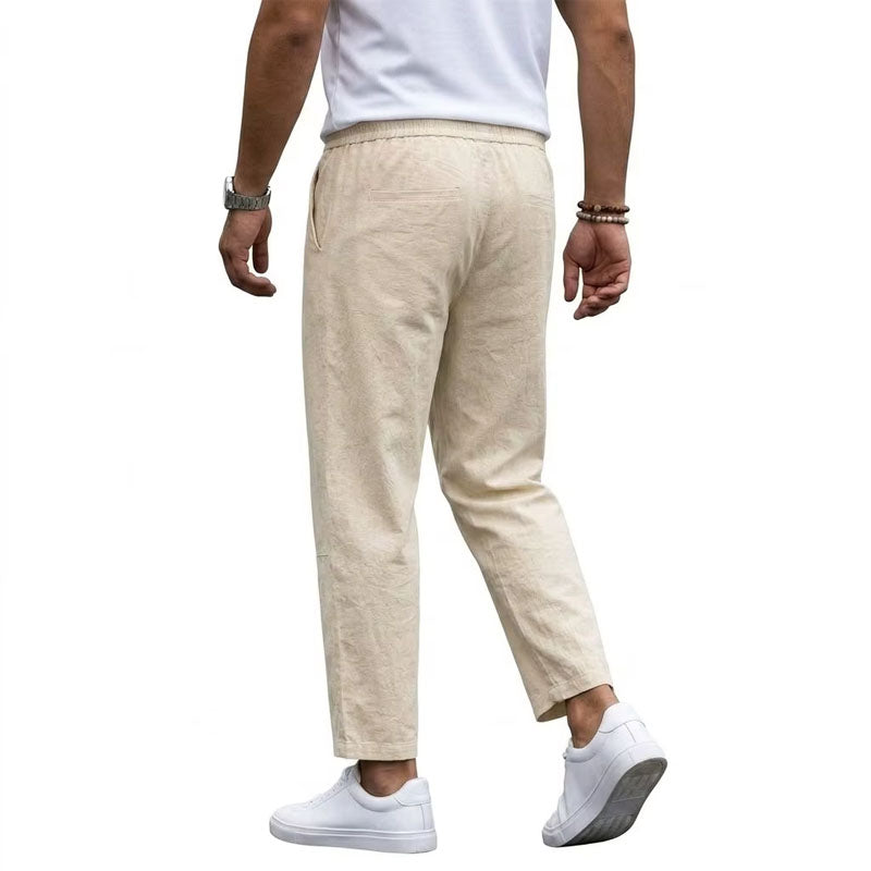 Male model in cropped casual pants with a clean silhouette on a plain background.