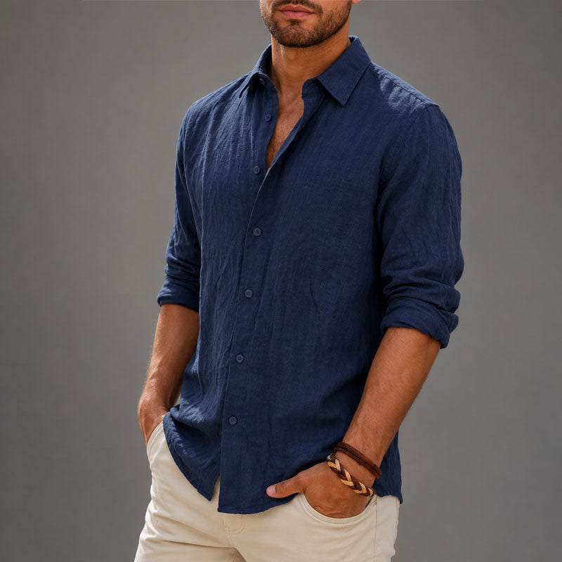  Male model styling a casual button down shirt with a relaxed fit on a plain background.