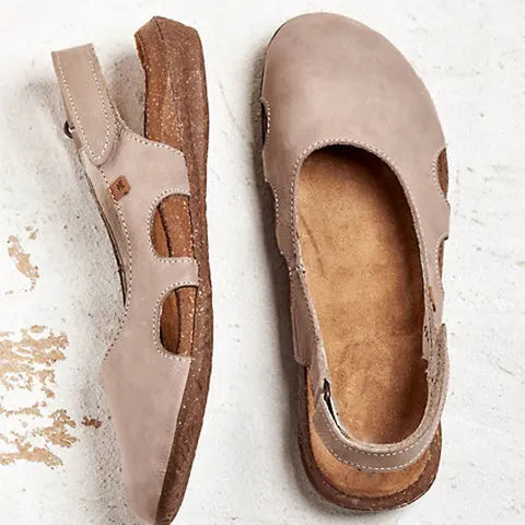 Close-up of supportive sandals on foot with open design.