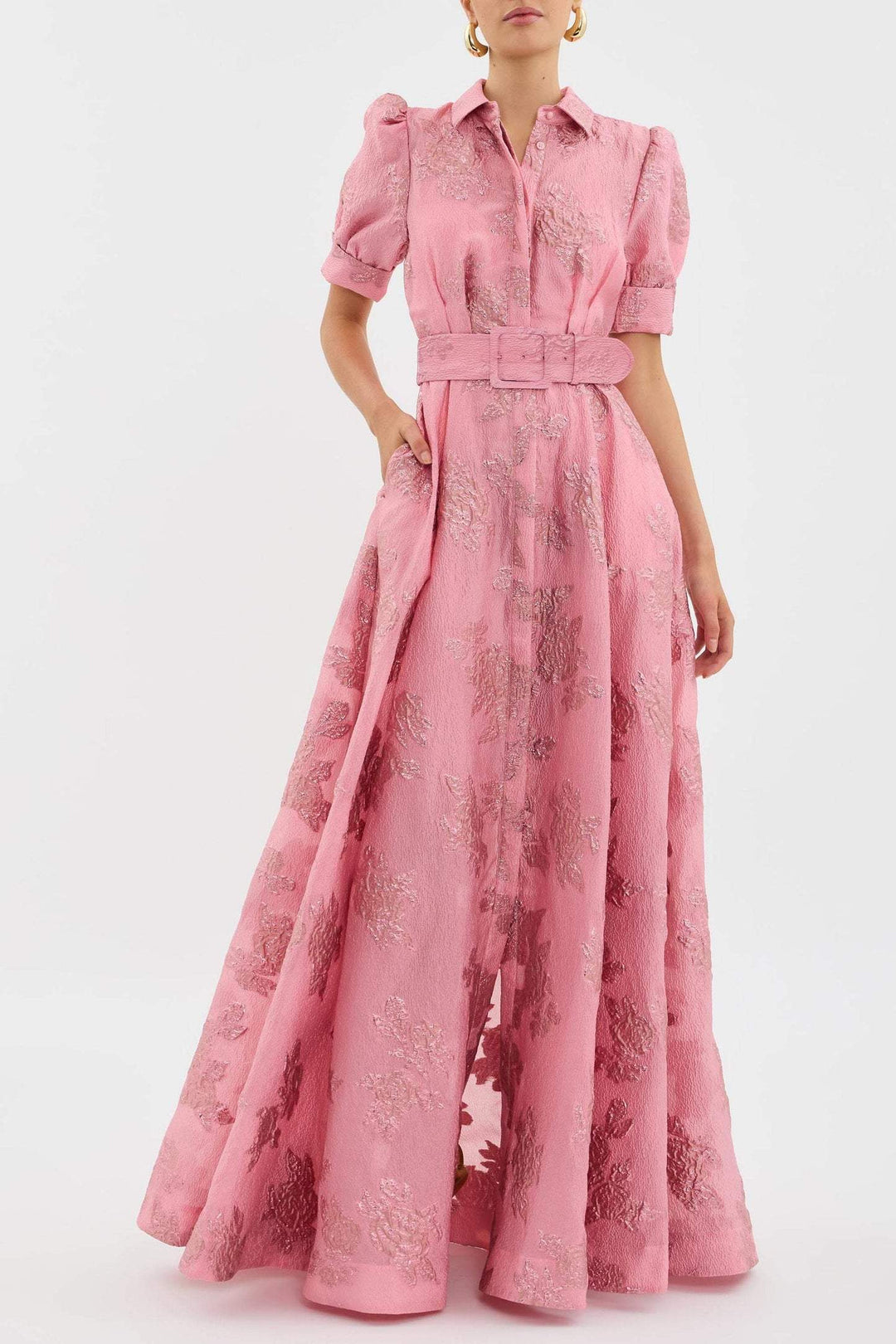 Female model wearing a pink retro high waist dress on a plain background.