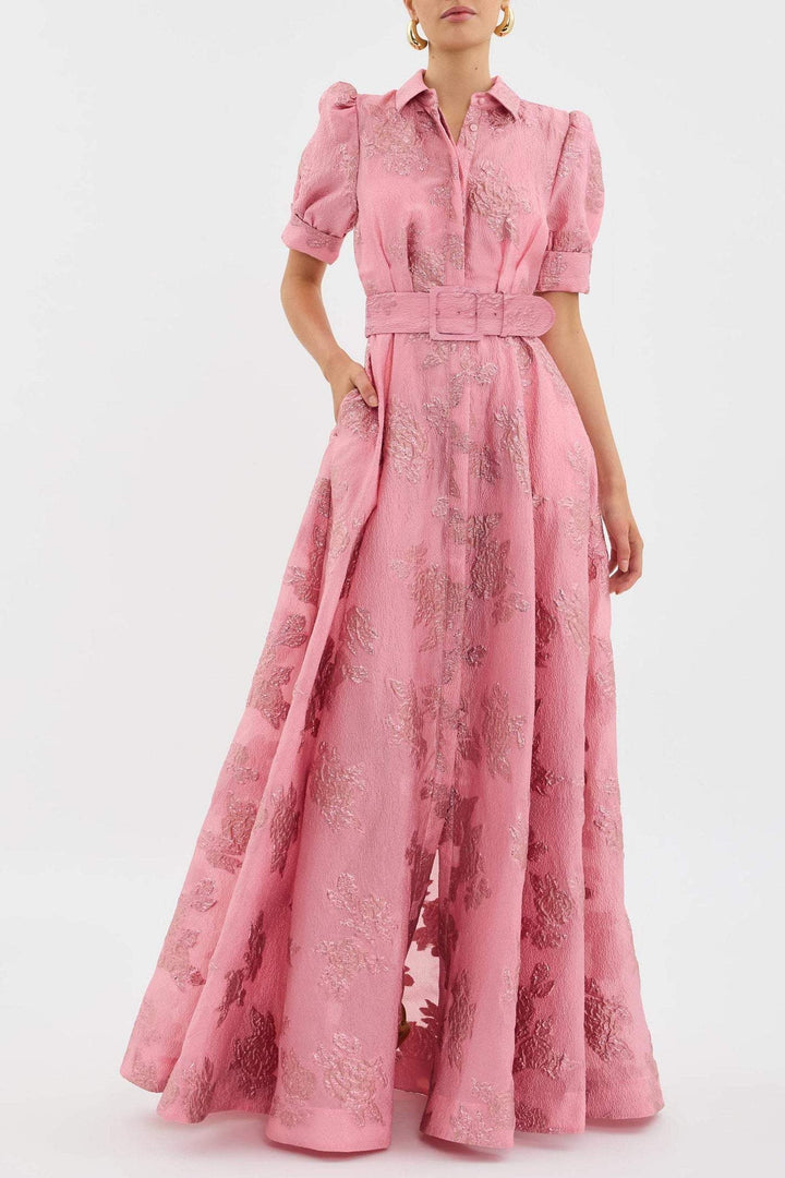 Female model wearing a pink retro high waist dress on a plain background.