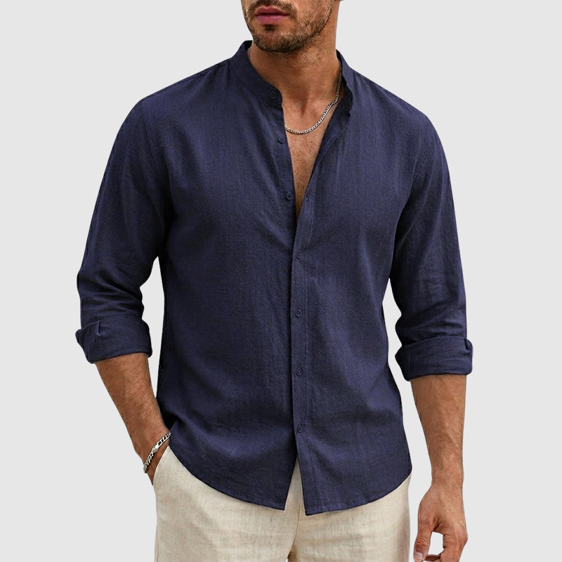 Female model wearing a stand collar button-front shirt against a plain background.
