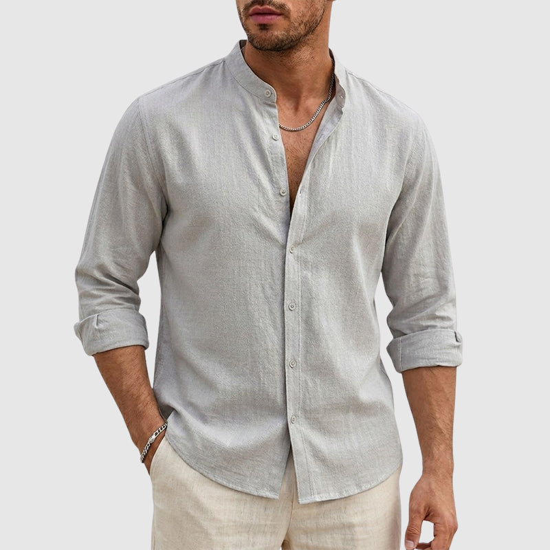 Woman standing in a lightweight woven shirt with a stand collar against a plain background.
