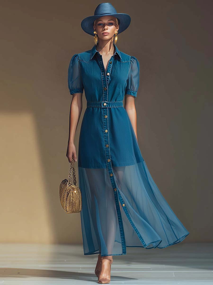  Woman showcasing a long denim dress with front buttons and a flowing silhouette on a plain background.