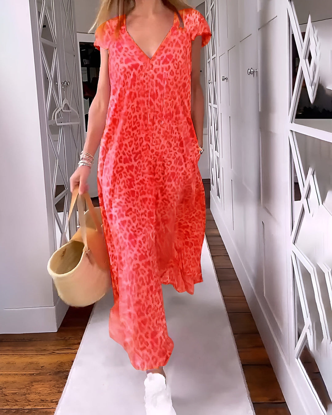Long animal print dress with short sleeves shown on a plain background.