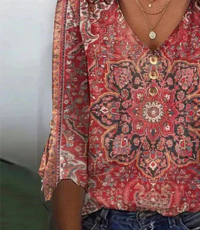 Close0-up blouse display centered on plain red background.