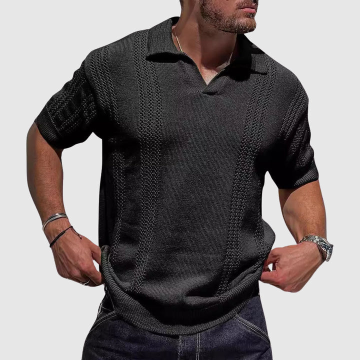 Male model wearing a textured open collar polo on a plain background