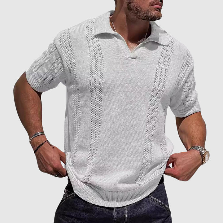  Male model in a relaxed textured polo with a clean open collar on a plain background