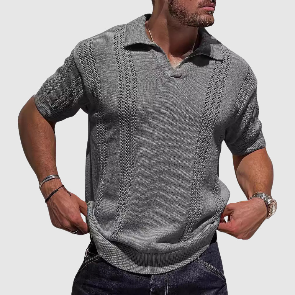  Male model showing a modern textured polo with vertical detail on a plain background