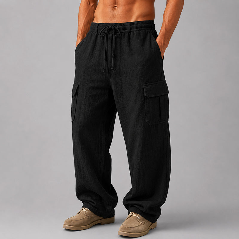 Male model in airy cropped pants with an adjustable waist on a plain background.