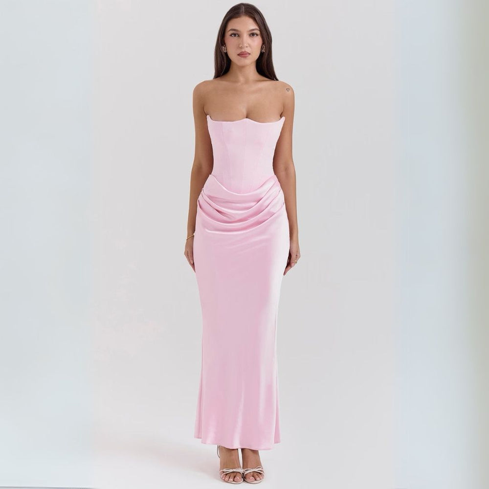 Model in an elegant satin strapless maxi dress with corset bodice and draped detail on a clean background.