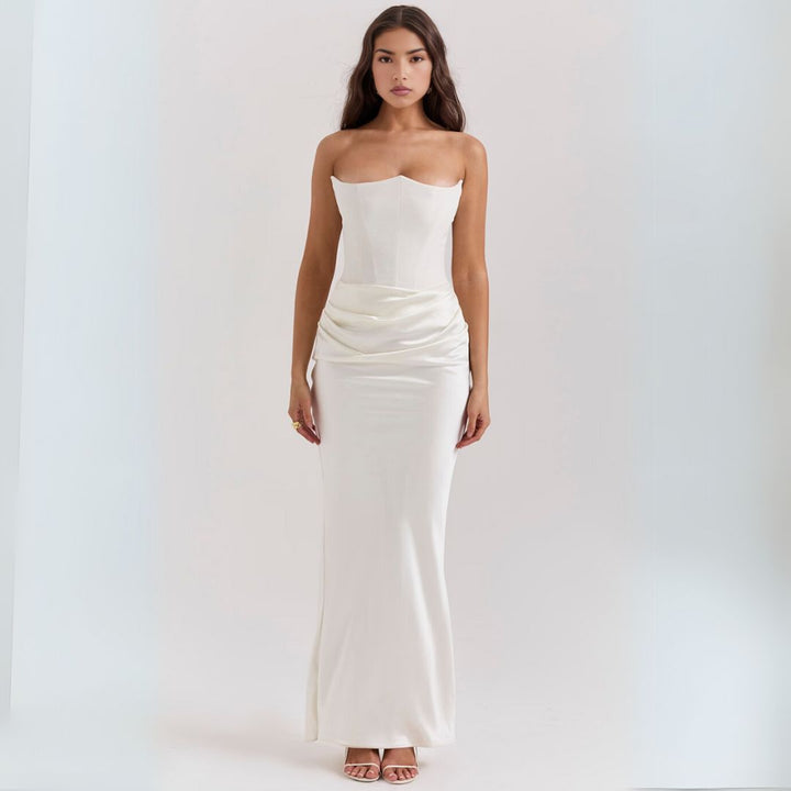 Model wearing a sleek satin corset maxi dress with strapless neckline on a clean background.