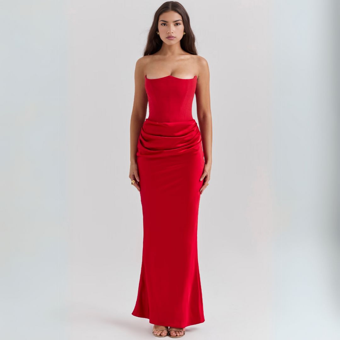 Female wearing a floor length satin corset dress with strapless neckline and refined draping.
