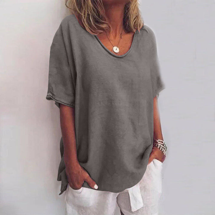 Flowy top featuring model details on a plain background, highlighting soft drape and comfort.