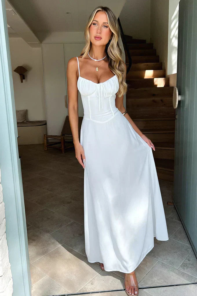 Female model wearing a graceful long dress in a calm staircase background
