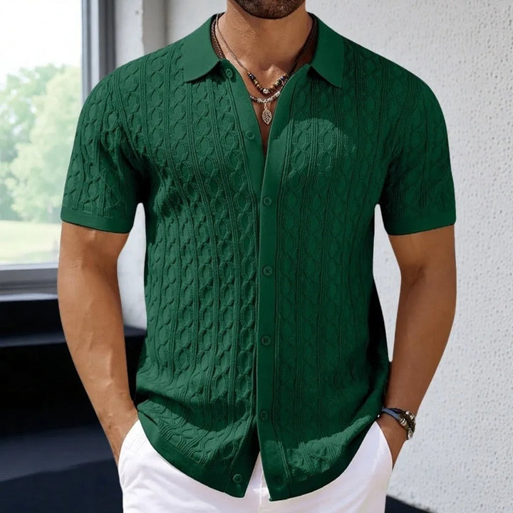  Male model presenting a patterned polo shirt with a button placket on a plain background.