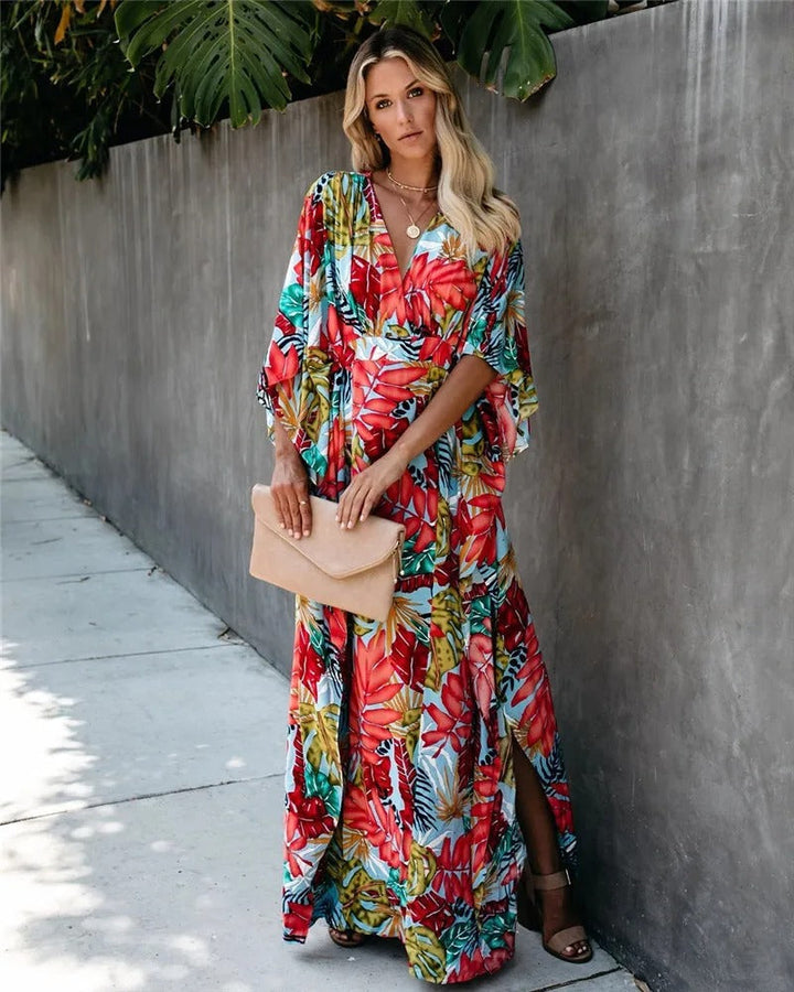 Female model showcasing a lightweight wrap dress with a long flowing skirt on a plain background.
