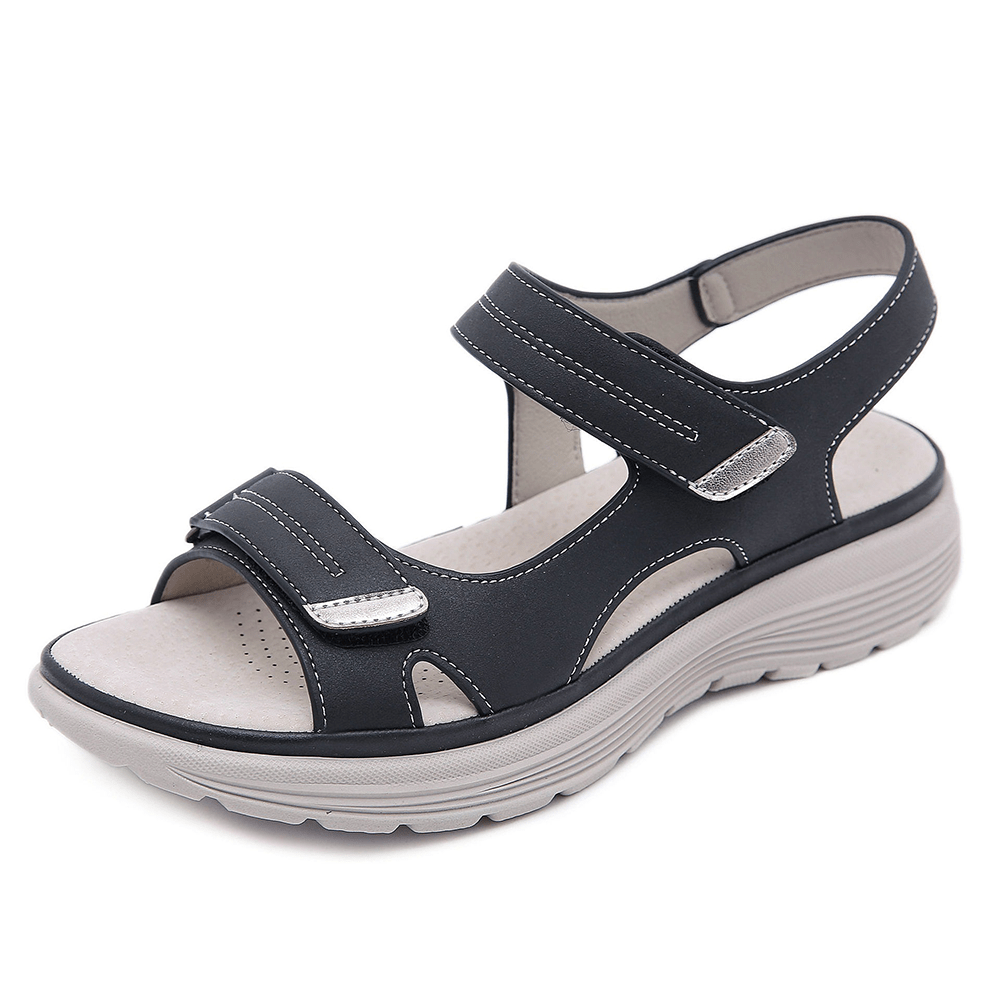 Close-up foot wearing supportive summer sandal on clean background.