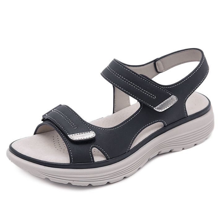 Close-up foot wearing supportive summer sandal on clean background.