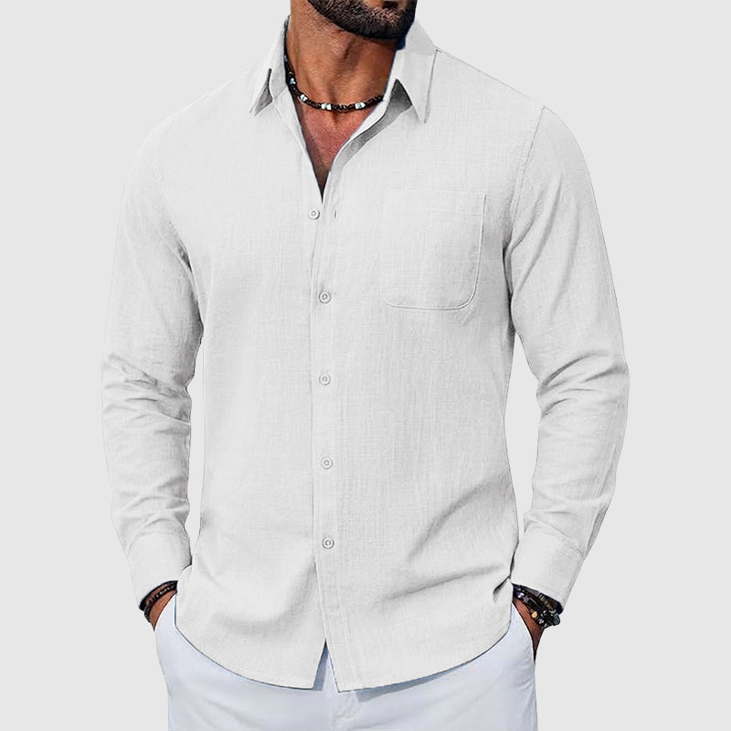 Woman wearing a casual collared shirt with a chest pocket against a plain background.